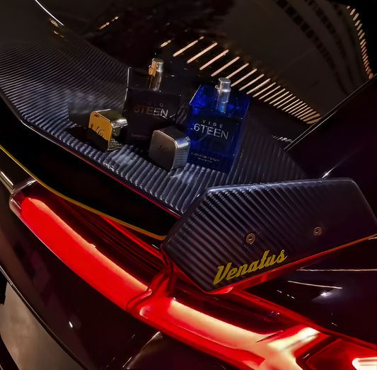 Two 6TEEN perfume bottles in black and blue with silver caps on a reflective dark surface with red lighting