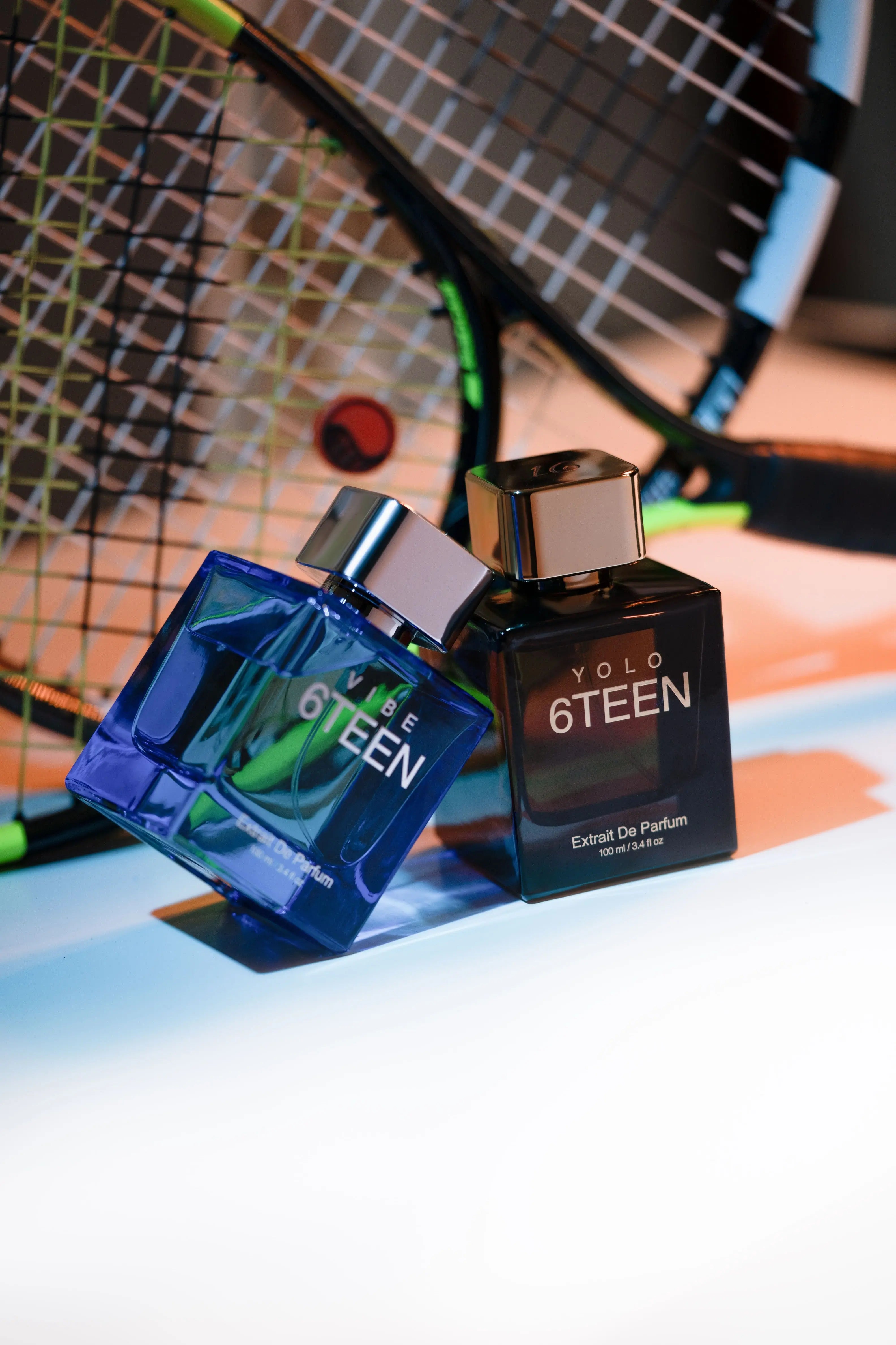 Vibe and Yolo 6TEEN Extrait De Parfum bottles with tennis racket background